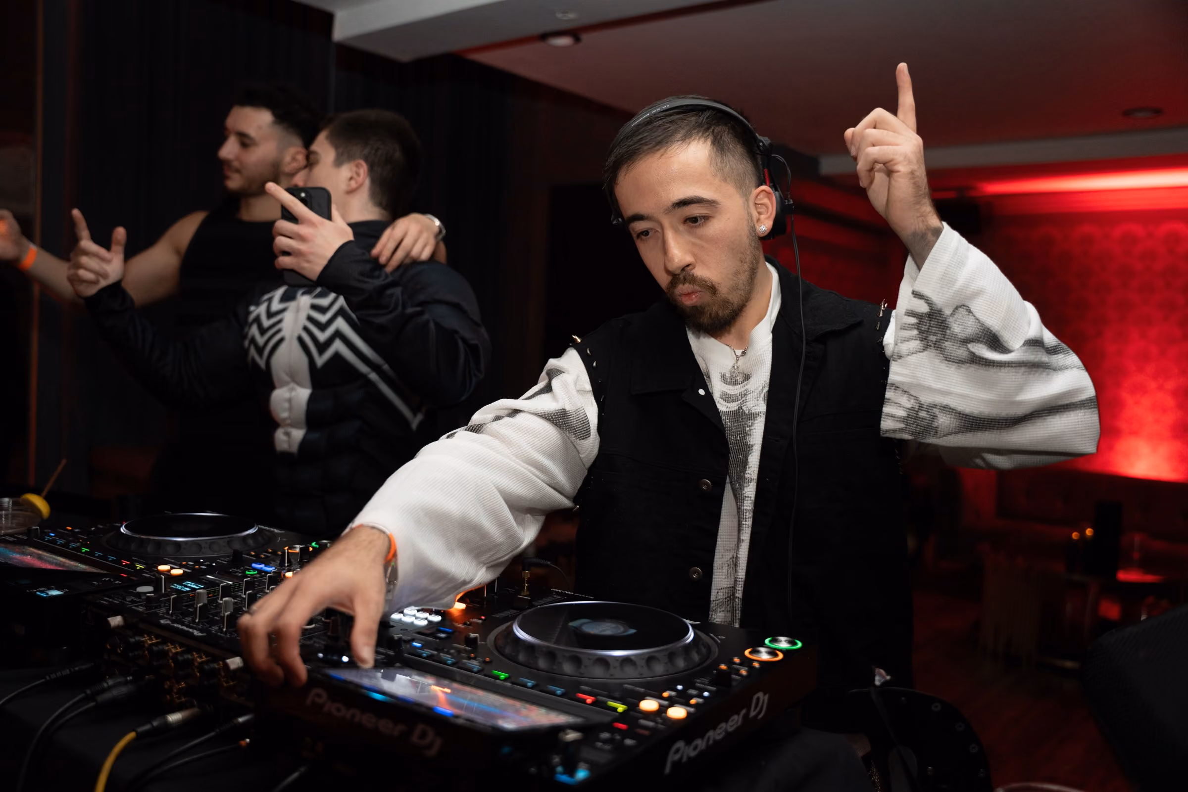 AED DJing at a club under red light